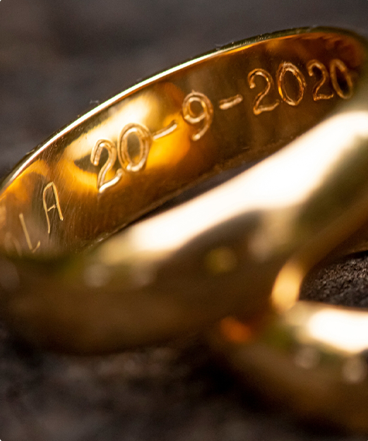 Intricate engraving on gold wedding band