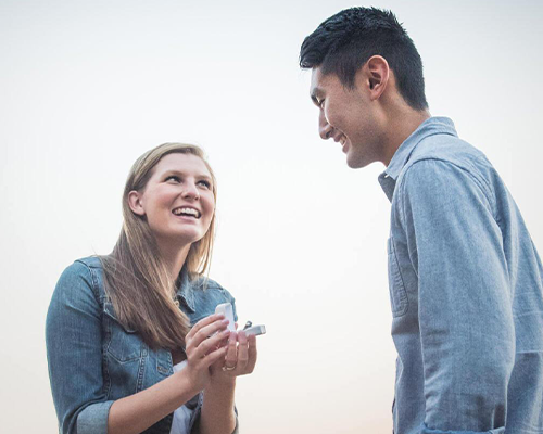 Bride-to-be gifting man engagement ring