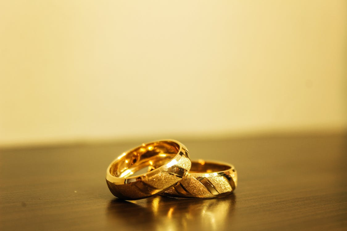 Close-up of hands buying an engagement ring