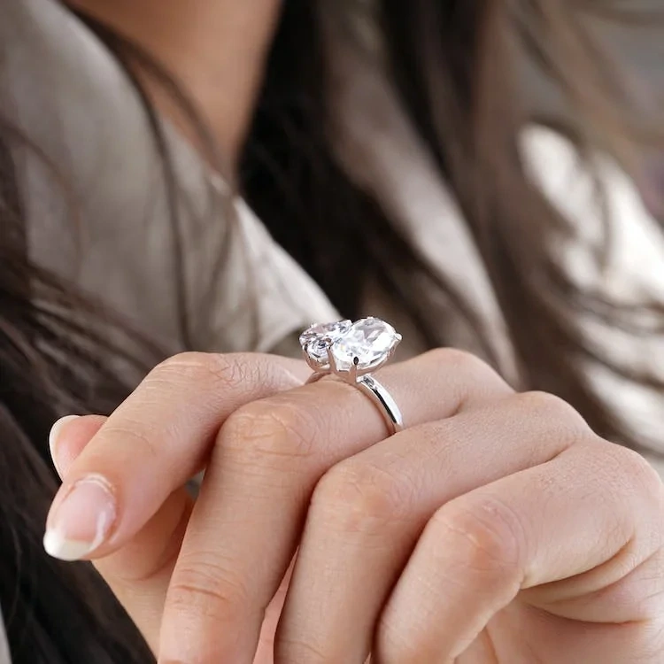 Elegant woman showcasing stunning diamond engagement ring