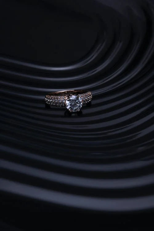 Close-up of hands buying an engagement ring