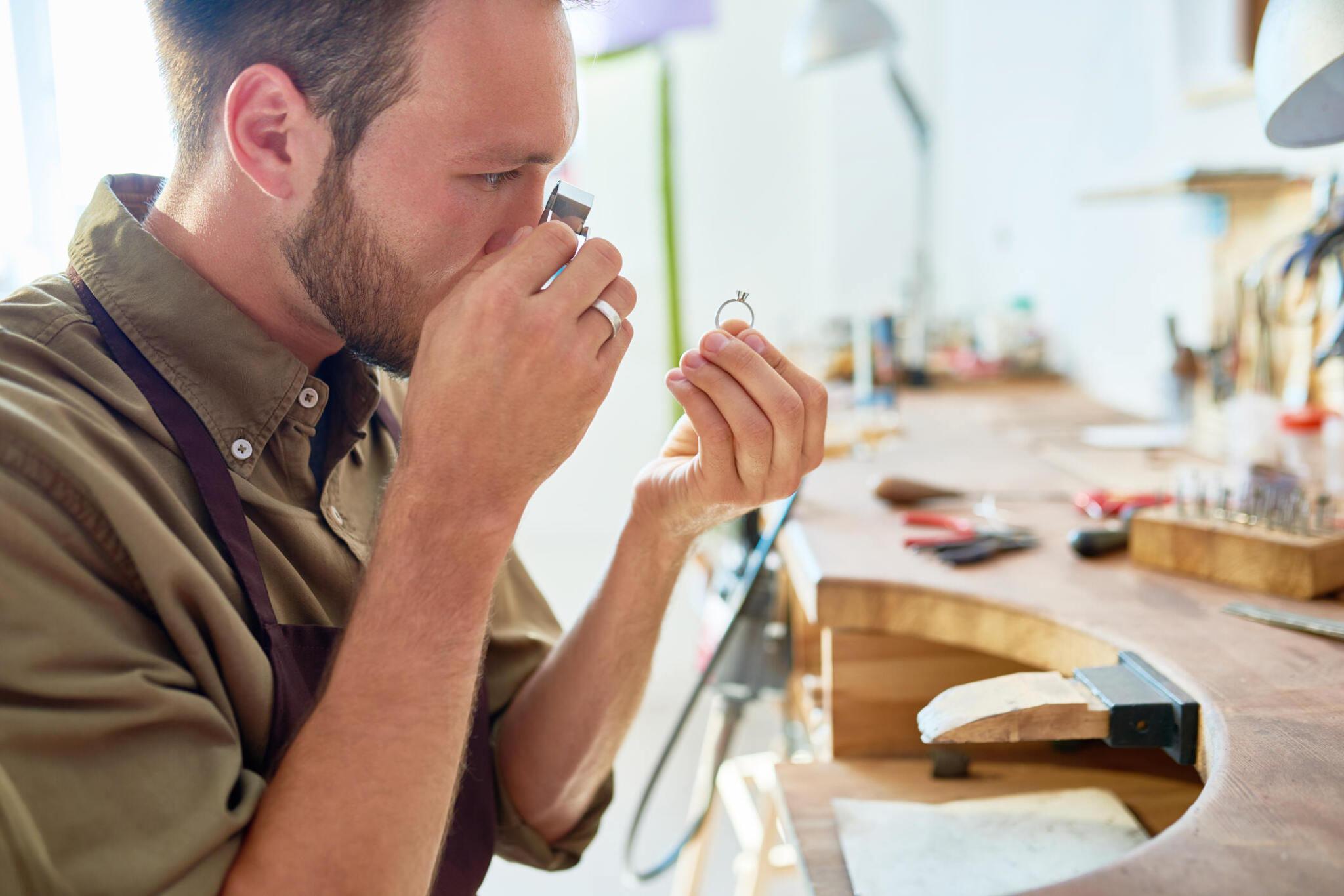 Man inspecting diamond engagement ring