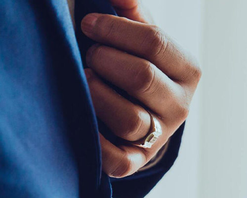 Man wearing suit with engagement ring