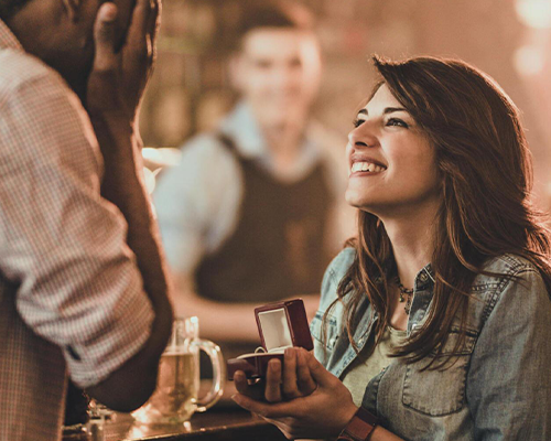 Woman happily proposing with engagement ring