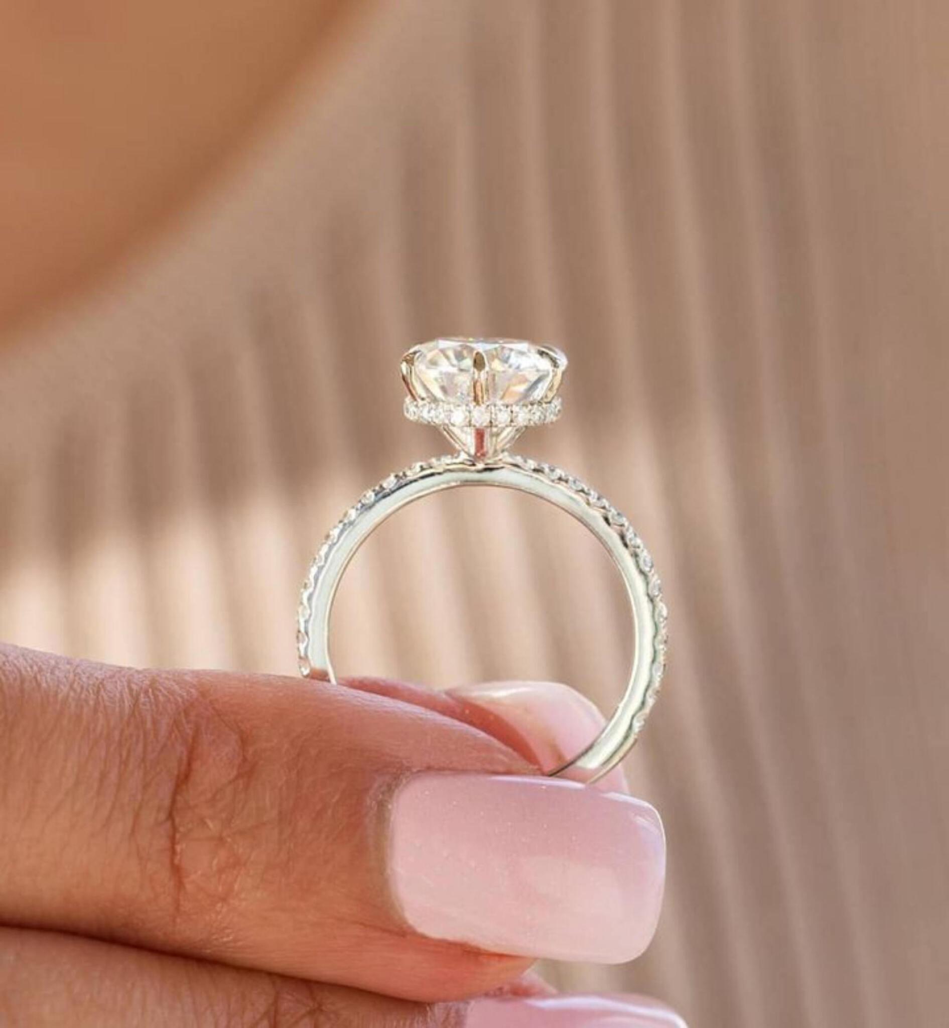 Woman's hand holding engagement ring