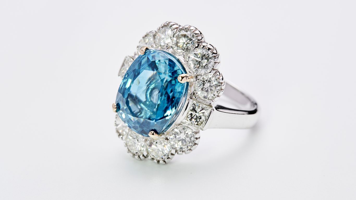 A blue gemstone ring with diamonds.