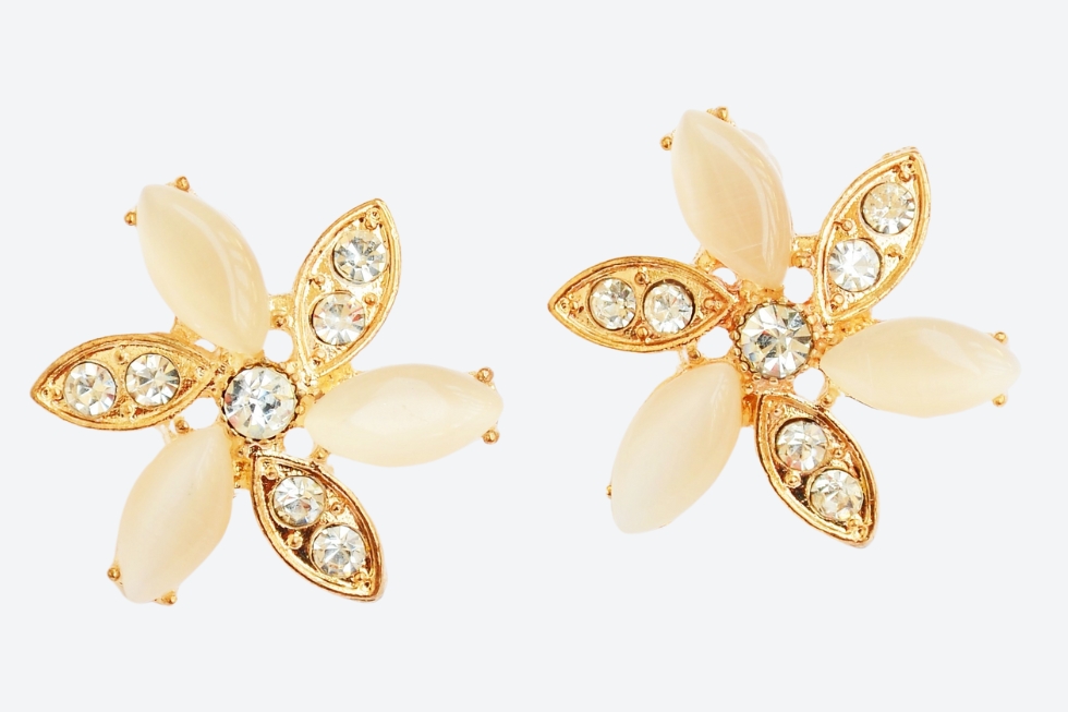 3 Gold flower-shaped earrings with crystal embellishments.