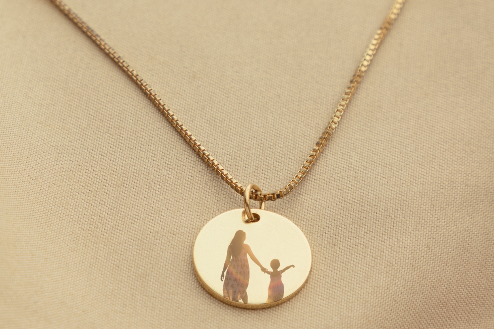 2 Gold pendant necklace with mother-daughter silhouette.