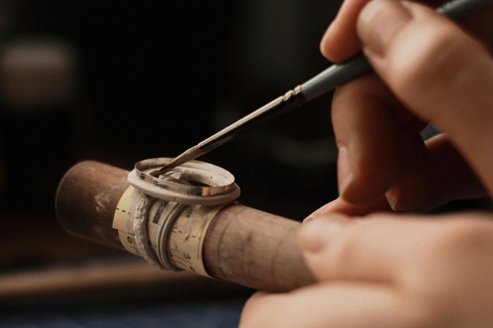 2 Handcrafting jewelry with precision tool close-up.