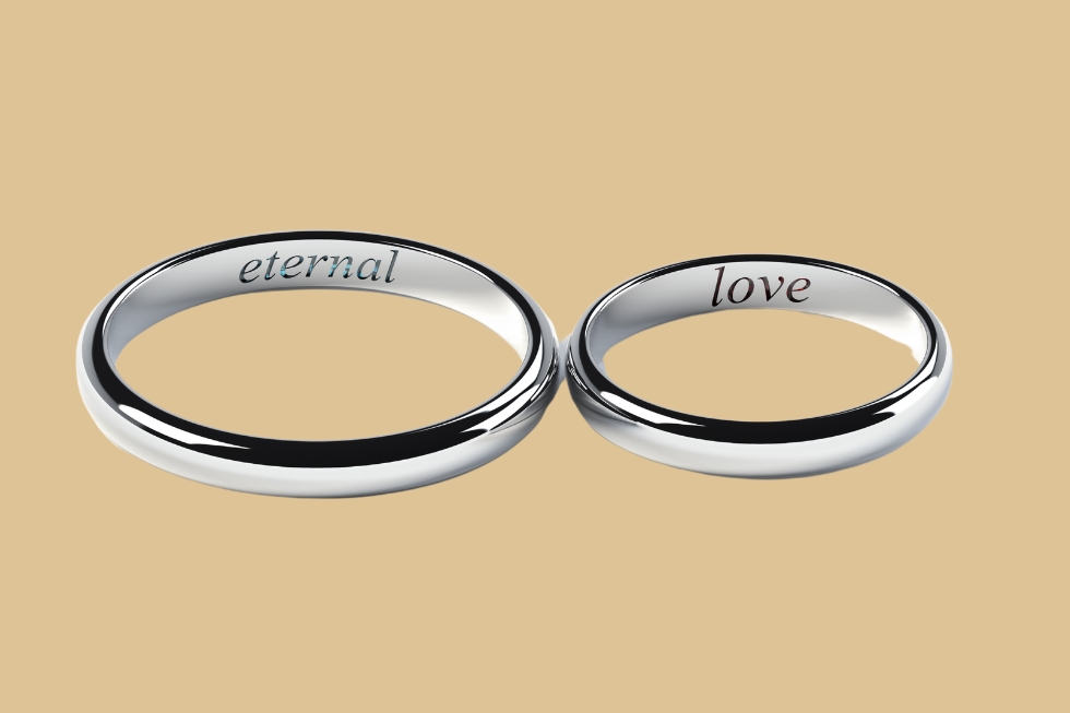 3 Two silver rings engraved with "eternal" and "love."