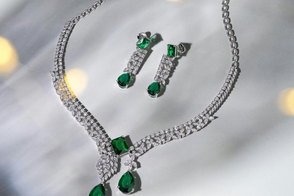3 Emerald and diamond jewelry set featuring an elegant necklace and matching drop earrings.