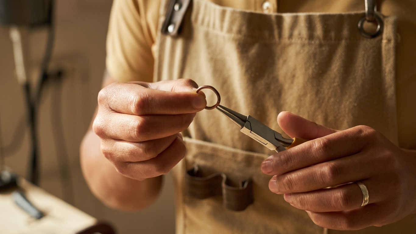 Person holding a ring with pliers.