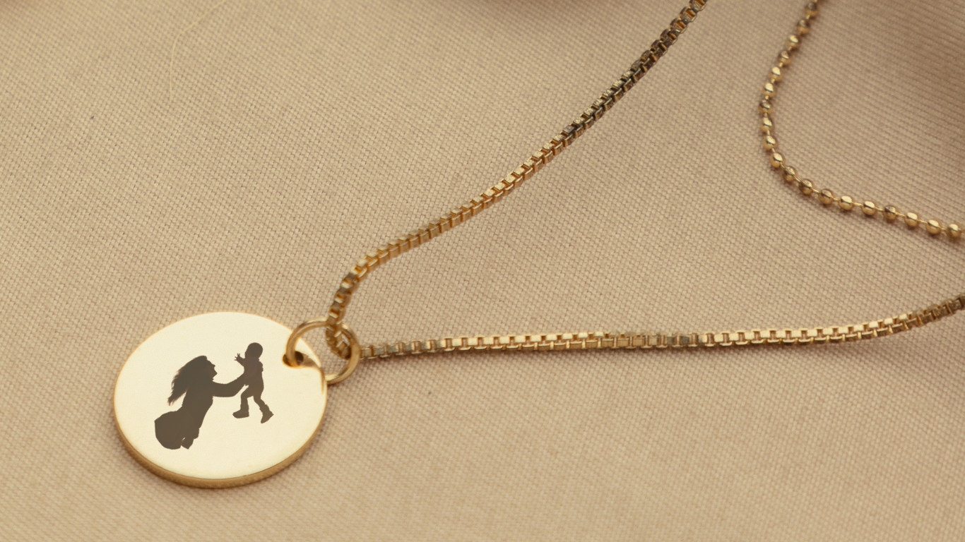 Gold necklace with engraved mom and toddler.