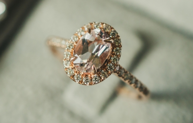 Vintage-style rose gold engagement ring featuring an oval morganite center stone.