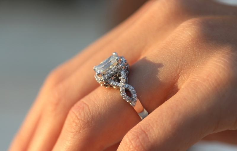 Twisted design and halo setting evoke a vintage-inspired ring.