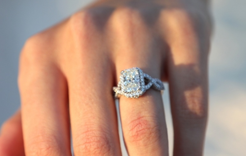 Halo setting and twisted band add antique-style flair.