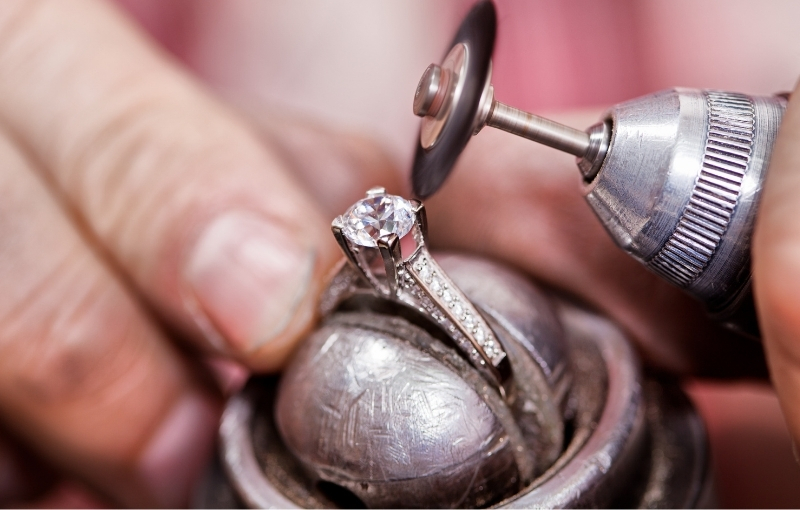 Polishing diamond engagement ring by hand.