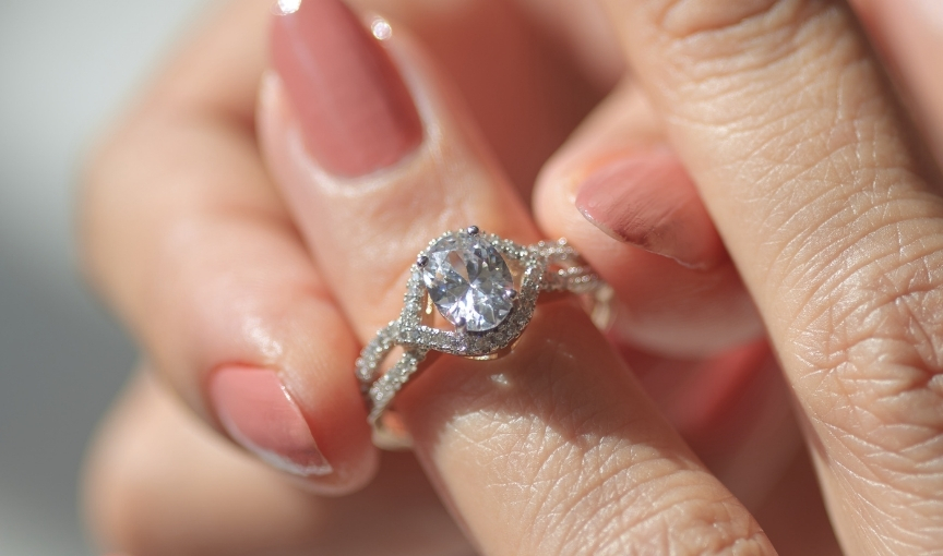 Vintage-style oval diamond halo engagement ring.