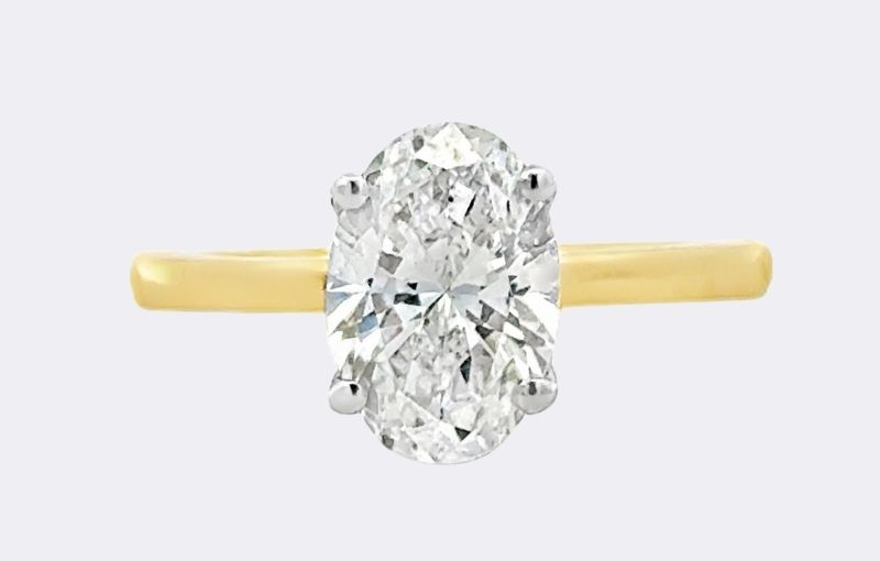 Gold band oval diamond ring.