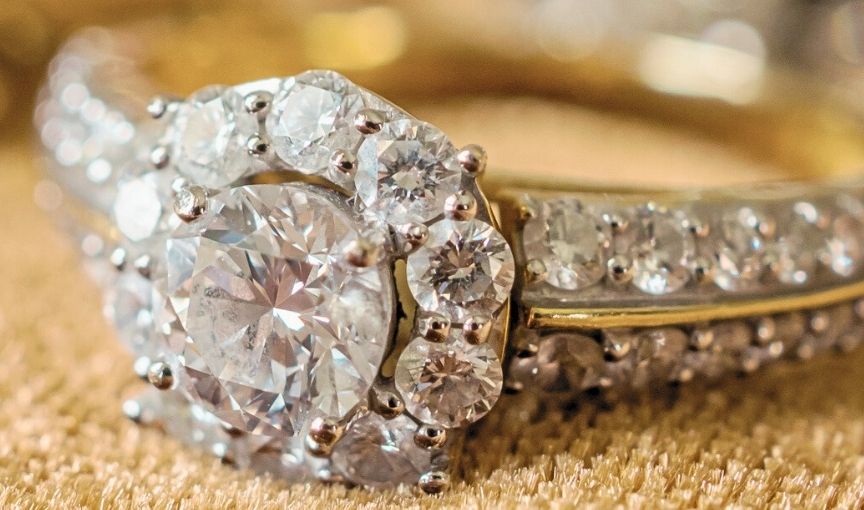 Close-up diamond cluster engagement ring.