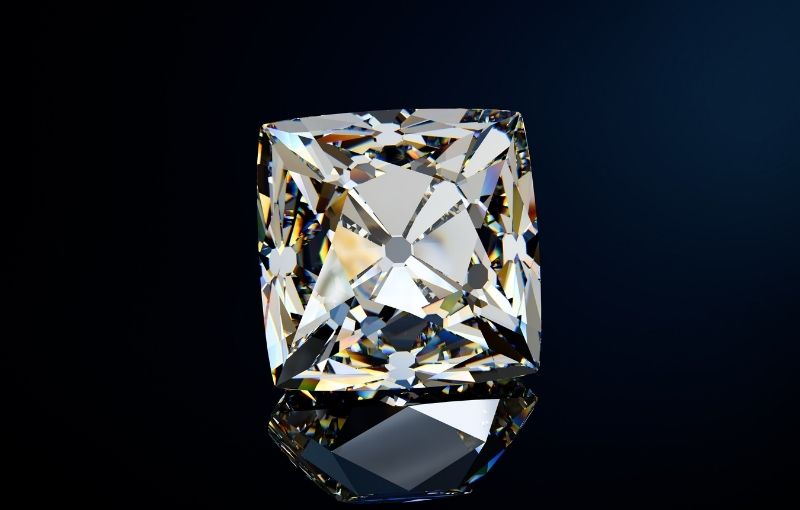 Cushion-cut diamond on dark background.