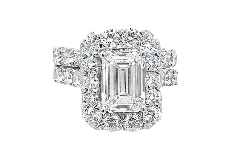 Emerald-cut diamond halo engagement ring.
