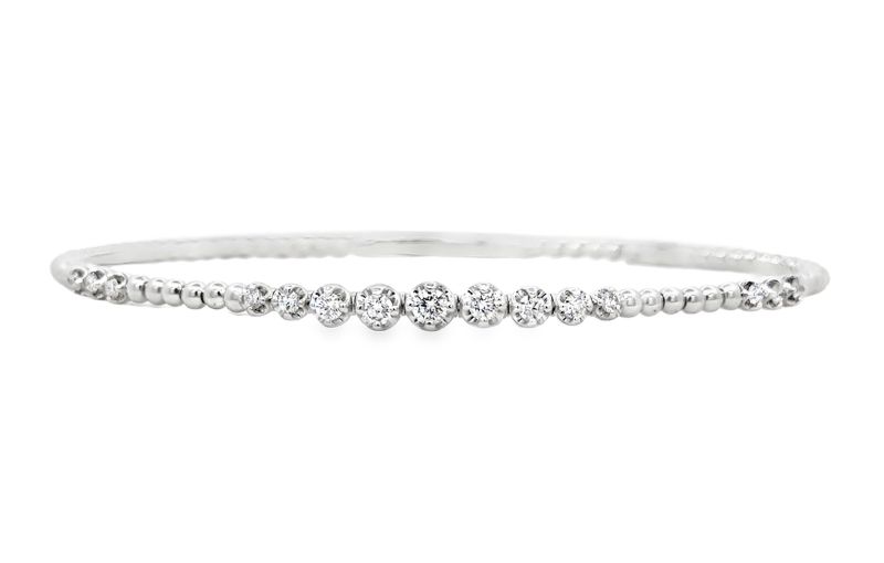 Diamond-studded silver bangle bracelet.