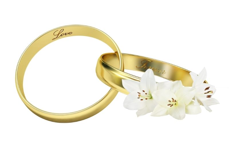 Gold wedding rings with "Love" and "Forever."
