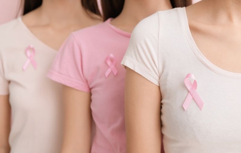 Women wearing pink ribbon pins.