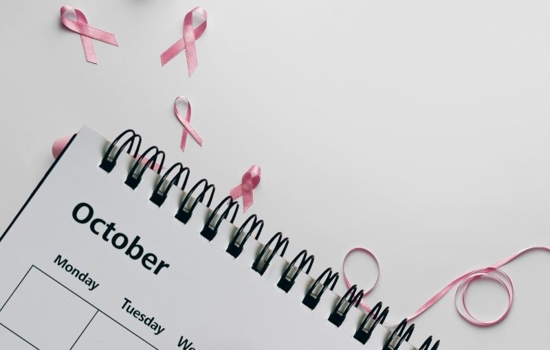 Pink ribbons with October calendar.