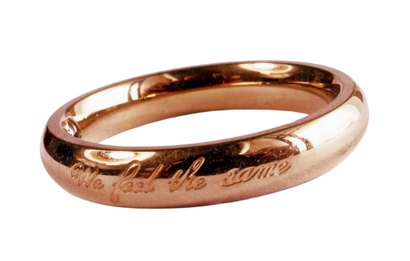 Rose gold ring engraved "We feel the same."
