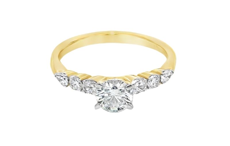 Gold band diamond cluster engagement ring.