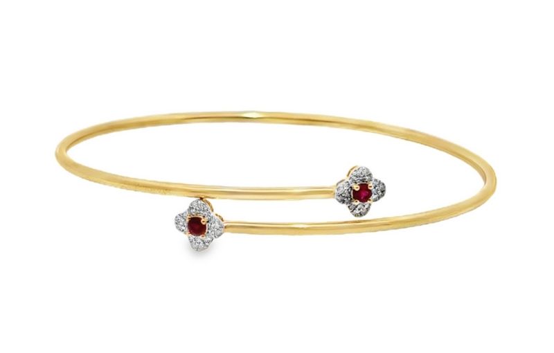 Gold bangle with ruby flowers.