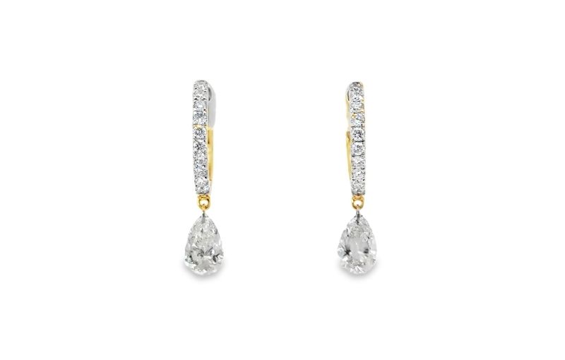 Gold drop earrings with pear diamonds.