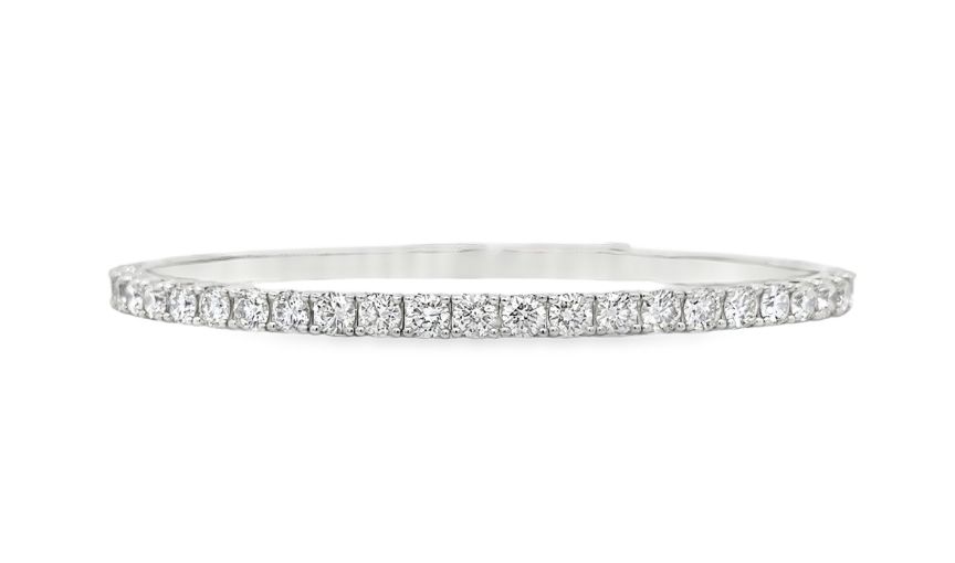 Diamond-studded white gold bangle bracelet.
