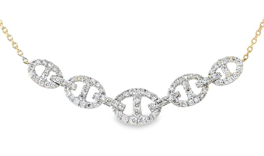 Diamond link necklace in gold setting.