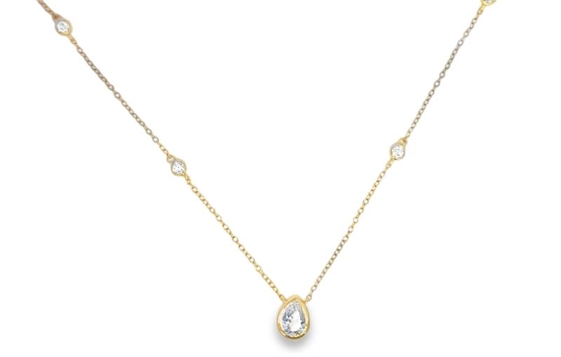 Gold necklace with teardrop diamond.