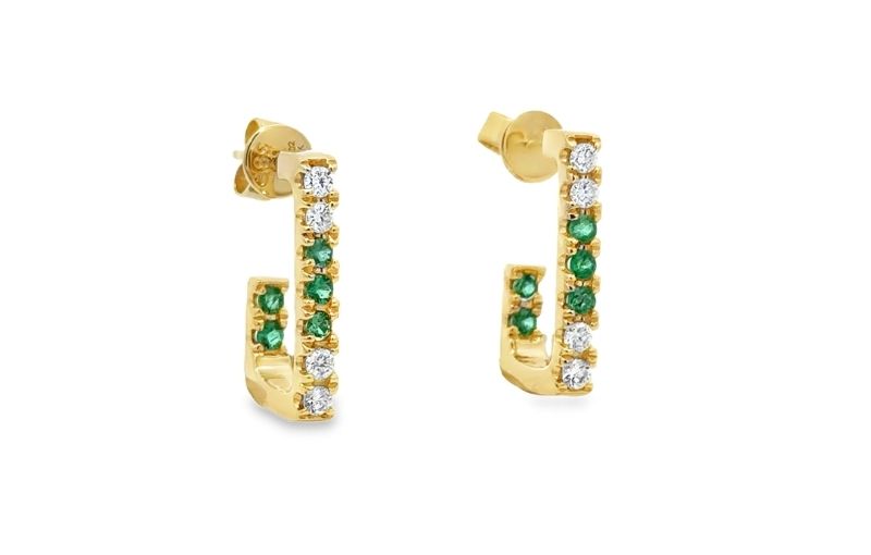 Gold earrings with emerald and diamond stones.