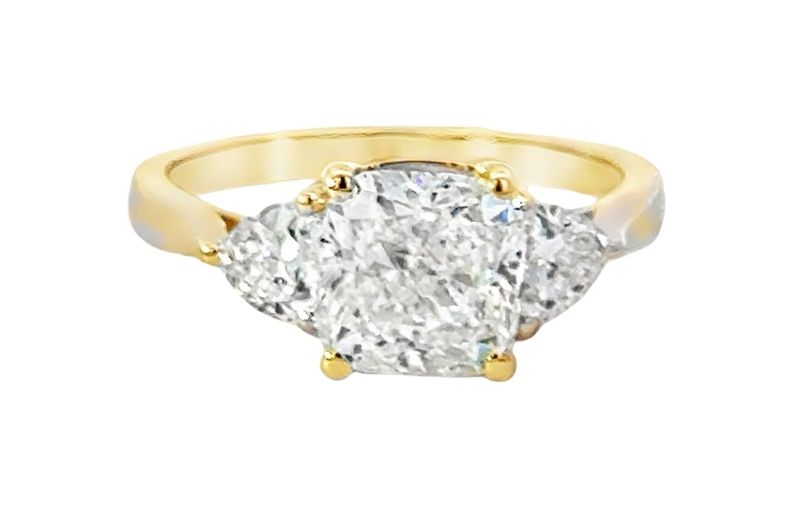 Three-stone cushion cut diamond ring.