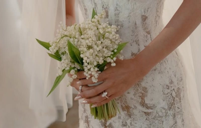 Selena Gomez holding lily of the valley bouquet.
