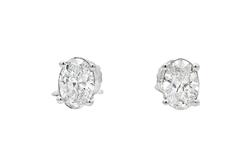 Oval-cut diamond stud earrings.