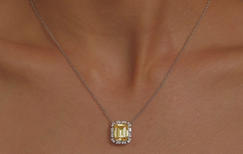 Yellow diamond halo pendant necklace.