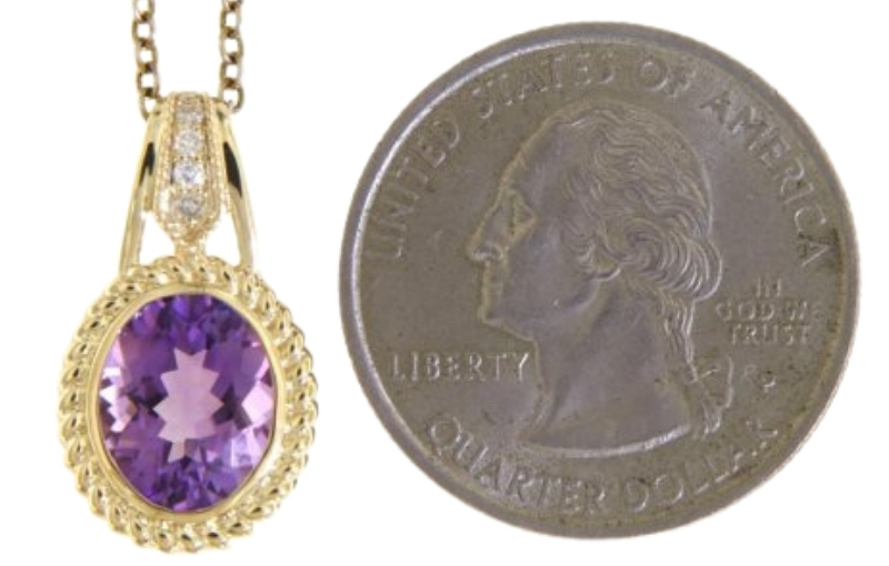 Gold amethyst pendant with quarter.
