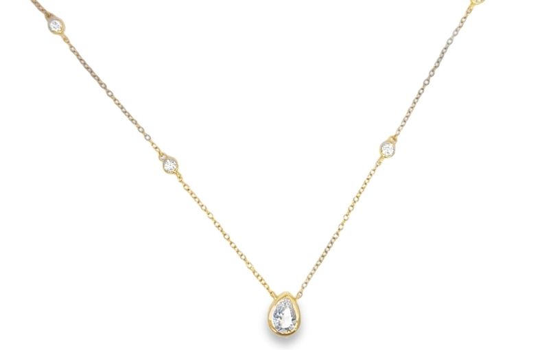 Pear diamond station necklace in yellow gold.