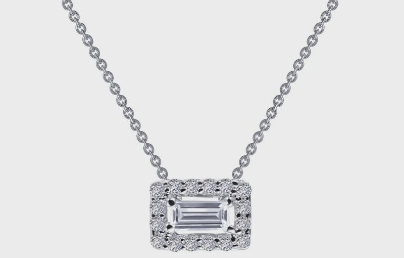 Emerald-cut diamond pendant with halo.