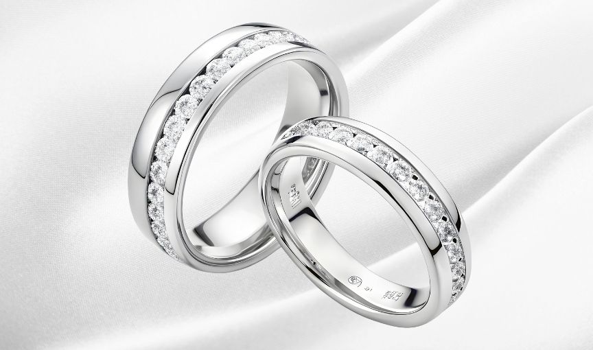 Two platinum wedding bands with diamonds.