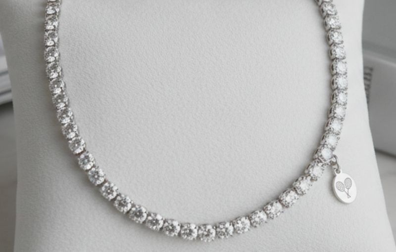 Diamond tennis necklace with charm.
