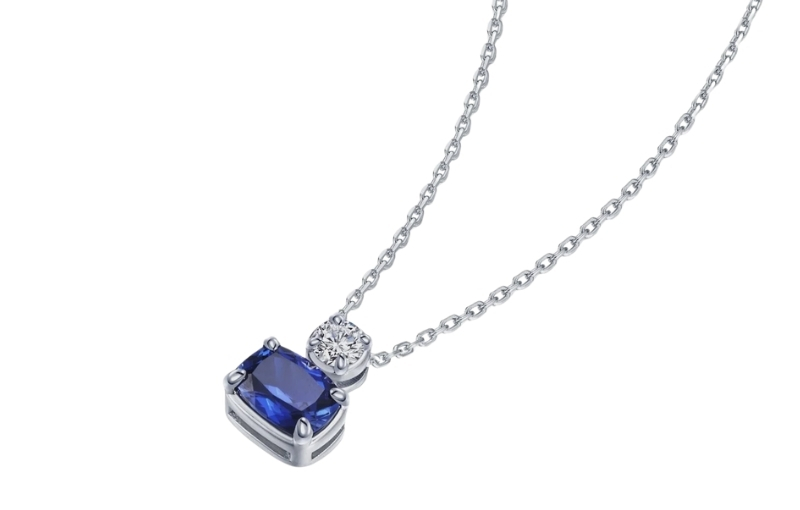Blue sapphire and diamond pendant necklace.