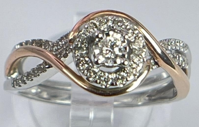 Two-tone diamond swirl halo ring.