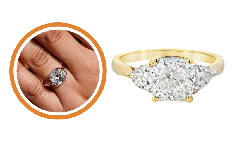 Oval diamond engagement ring on finger.